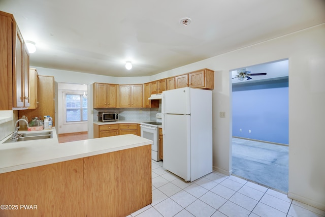 3122 Sparrow Ct, East Stroudsburg, PA 18302 - kitchen with white appliances, under cabinet range hood, a peninsula, light countertops, and decorative backsplash