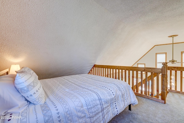 carpeted bedroom featuring vaulted ceiling and a textured ceiling