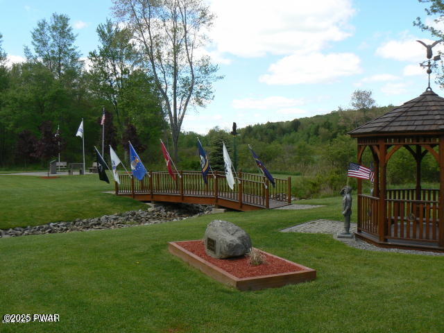 view of jungle gym featuring a gazebo and a lawn