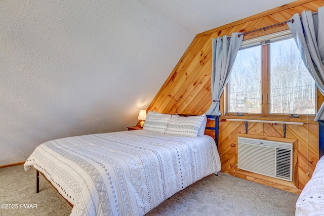 bedroom with carpet floors, vaulted ceiling, an AC wall unit, and wood walls