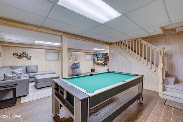 playroom featuring wooden walls and a paneled ceiling