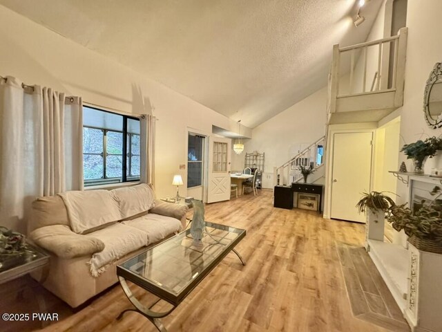 235 Falling Waters Blvd, Lackawaxen, PA 18435 - living area featuring light wood finished floors, a textured ceiling, and high vaulted ceiling