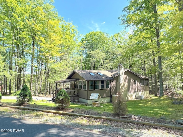 130 Grasshopper Ln, Greentown, PA 18426 - view of front of home with a forest view, roof with shingles, a front yard, and a chimney