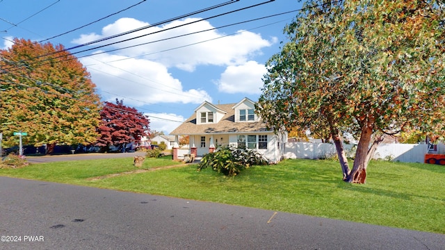 cape cod-style house featuring a front yard