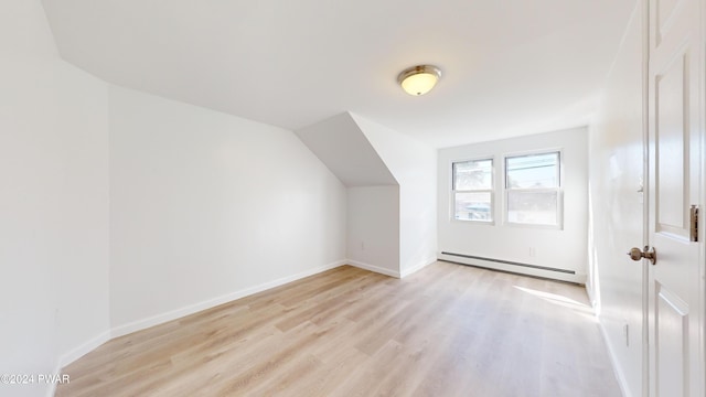 bonus room featuring light hardwood / wood-style flooring and a baseboard radiator