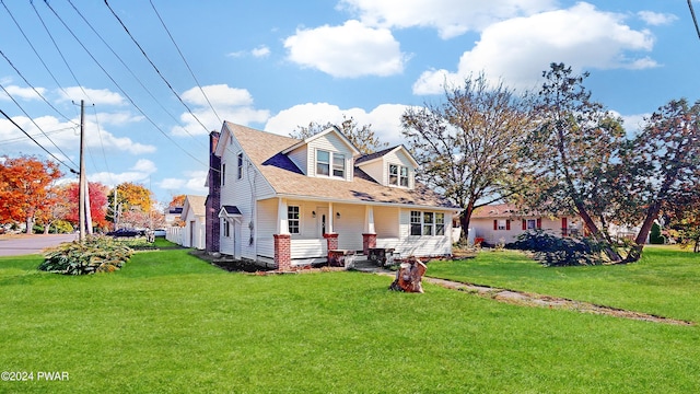 cape cod home with covered porch and a front lawn