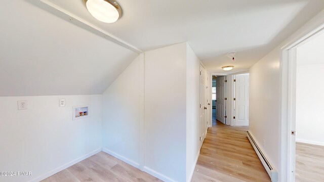 hall featuring light hardwood / wood-style floors, lofted ceiling, and baseboard heating