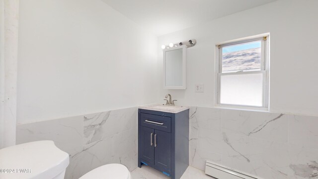 bathroom featuring toilet, vanity, tile walls, and a baseboard heating unit