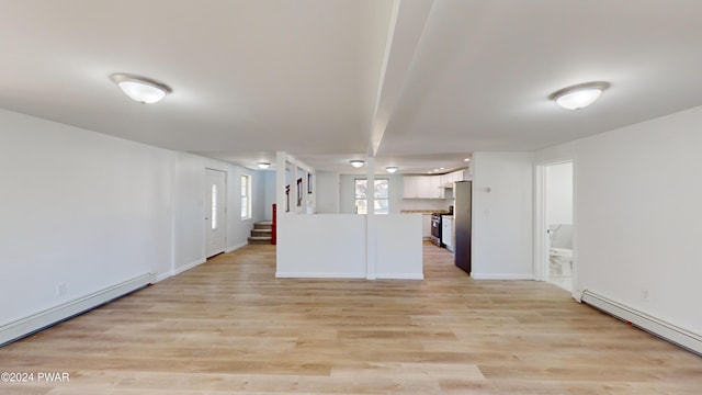 interior space with light hardwood / wood-style floors and a baseboard heating unit