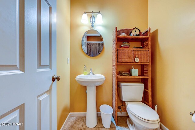 bathroom with toilet and tile patterned floors