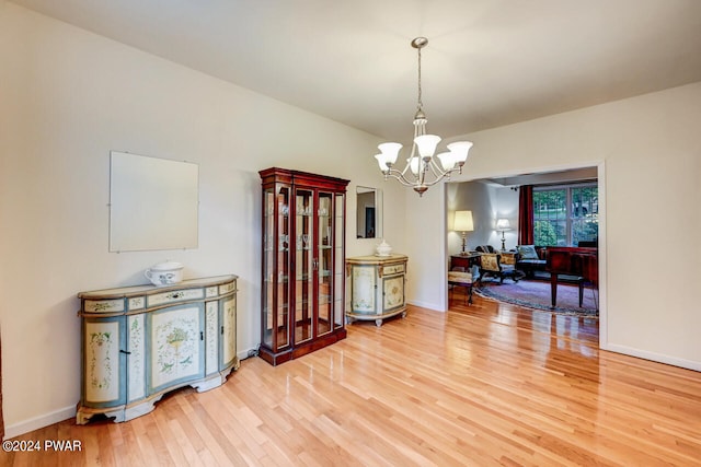 dining room with hardwood / wood-style flooring and a notable chandelier