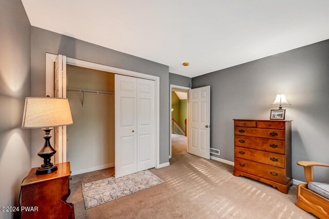 carpeted bedroom with a closet