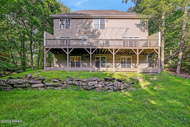 rear view of house with a lawn and a deck