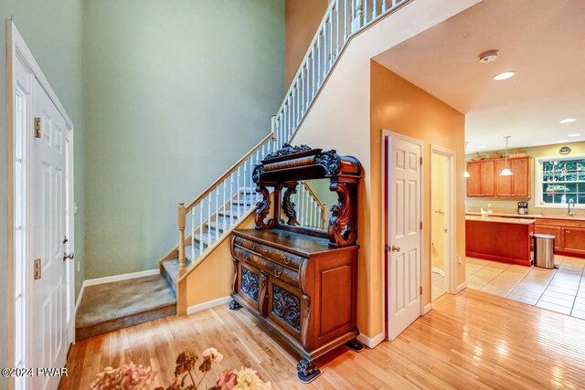 entrance foyer with sink and light hardwood / wood-style flooring