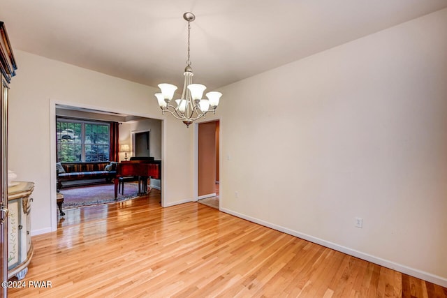 dining room featuring hardwood / wood-style flooring and an inviting chandelier