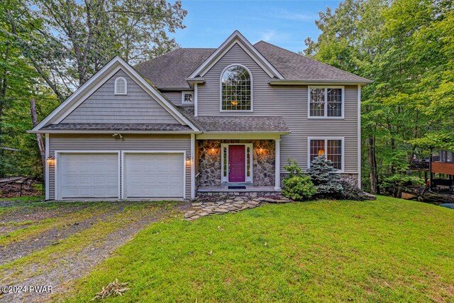 view of front of house featuring a garage and a front lawn