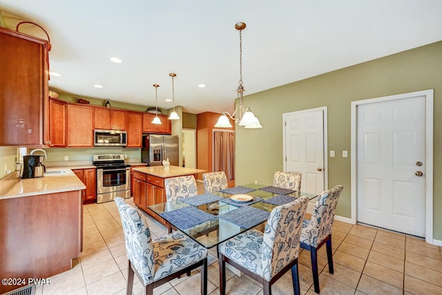 dining space featuring sink, light tile patterned flooring, and a chandelier