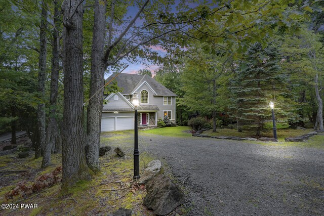 view of front of property with a yard and a garage