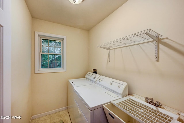 clothes washing area with independent washer and dryer and sink