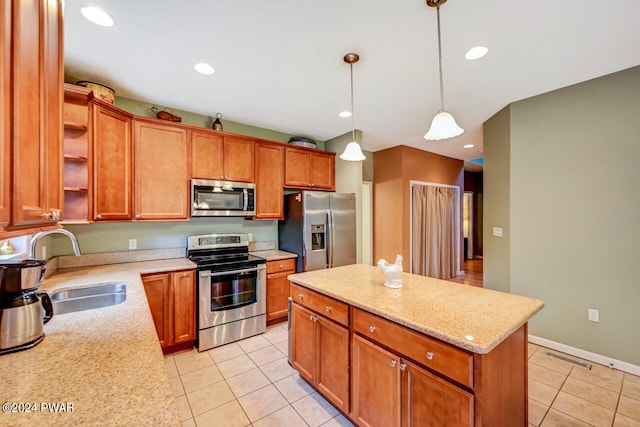 kitchen featuring sink, stainless steel appliances, light tile patterned floors, decorative light fixtures, and a kitchen island