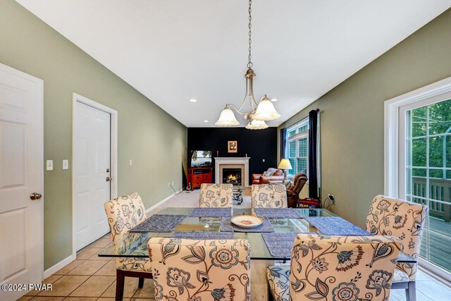 tiled dining space featuring a chandelier