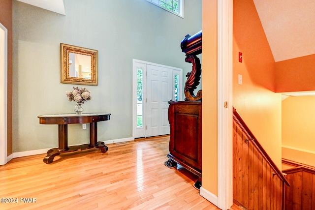 foyer featuring light hardwood / wood-style floors and a high ceiling