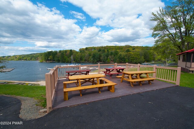 exterior space with a deck with water view