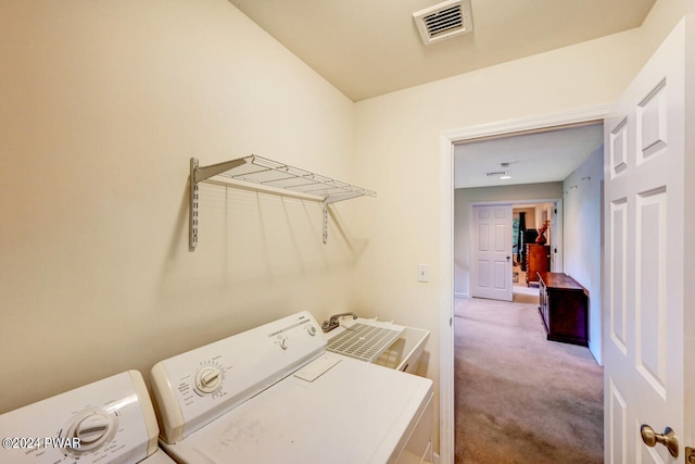 laundry area featuring washer and dryer, carpet, and sink