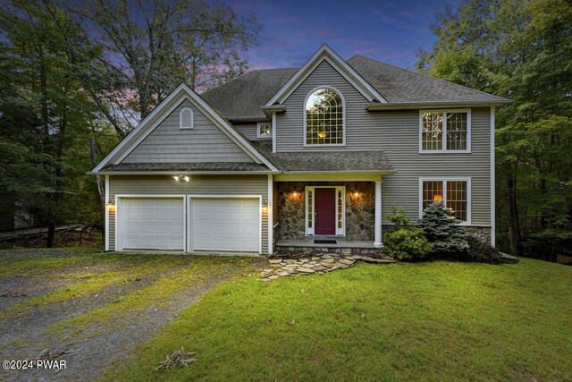 view of front of property with a lawn and a garage