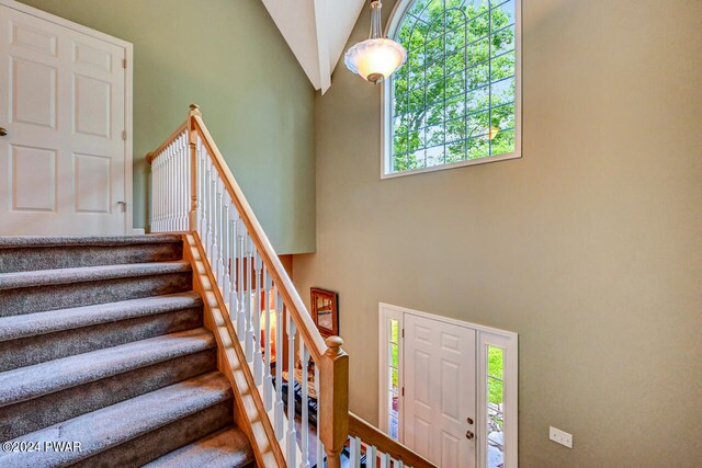 stairway with high vaulted ceiling