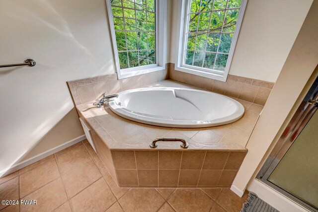 bathroom featuring tile patterned floors and separate shower and tub