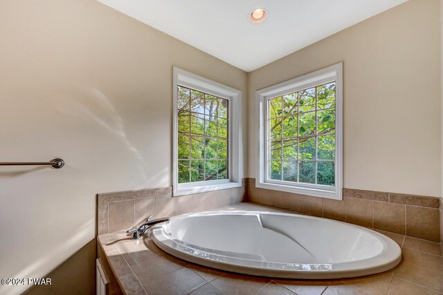 bathroom featuring a relaxing tiled tub