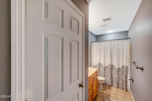 bathroom with walk in shower, tile patterned flooring, vanity, and toilet