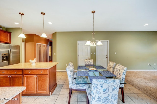 tiled dining space featuring a chandelier