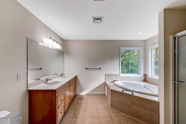 bathroom featuring vanity, tile patterned floors, and separate shower and tub