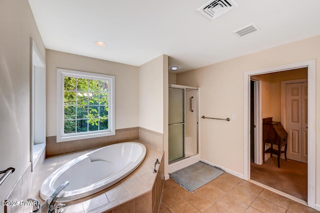 bathroom with tile patterned flooring and plus walk in shower