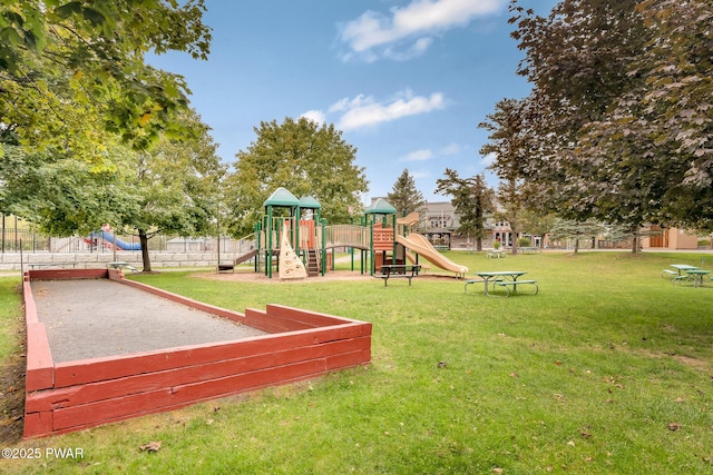community jungle gym with a yard and fence