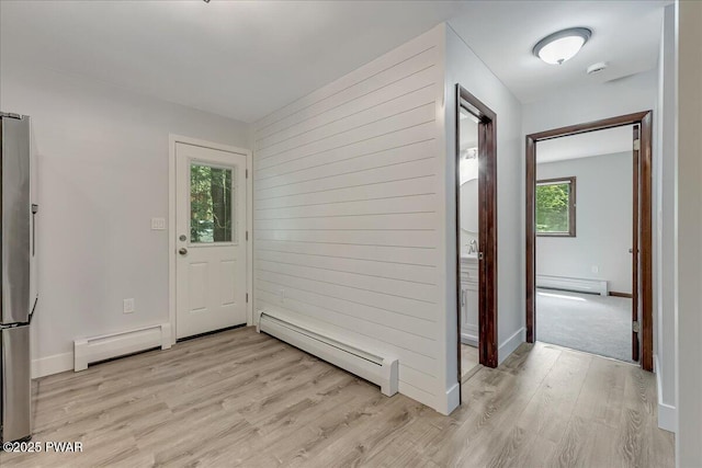 1180 Wallenpaupack Dr, Lake Ariel, PA 18436 - foyer entrance featuring baseboard heating, wood walls, and light wood-style floors