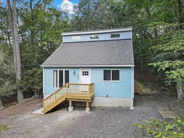 1180 Wallenpaupack Dr, Lake Ariel, PA 18436 - view of front of property featuring a shingled roof, stairway, and view of scattered trees