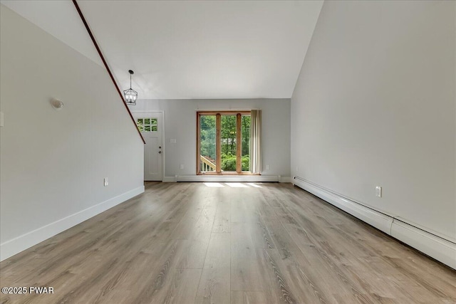 1180 Wallenpaupack Dr, Lake Ariel, PA 18436 - unfurnished living room with a baseboard radiator, wood finished floors, and lofted ceiling