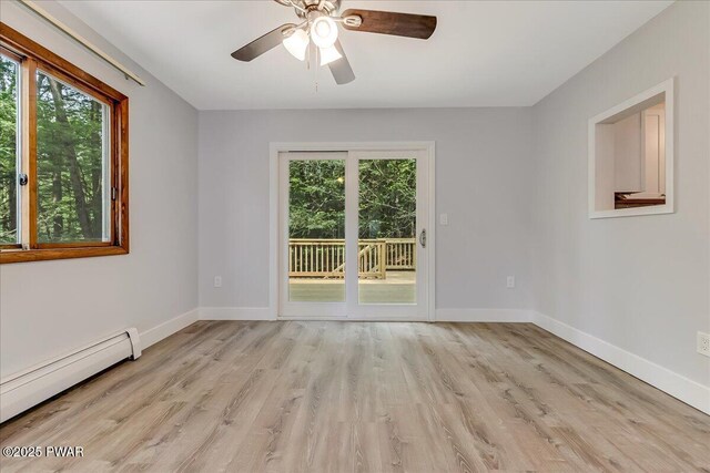 1180 Wallenpaupack Dr, Lake Ariel, PA 18436 - unfurnished room featuring baseboard heating, healthy amount of natural light, light wood finished floors, and ceiling fan