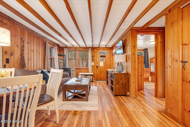 91 Bruin Rd, Lake Ariel, PA 18436 - living room with a wood stove, wooden walls, light wood finished floors, and beamed ceiling