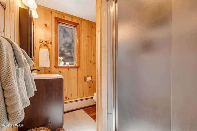 91 Bruin Rd, Lake Ariel, PA 18436 - full bath with a baseboard radiator, a shower stall, wood finished floors, wood walls, and vanity