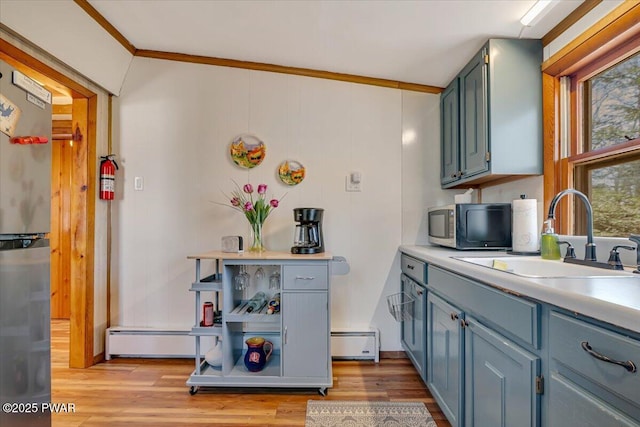 91 Bruin Rd, Lake Ariel, PA 18436 - kitchen with a sink, crown molding, appliances with stainless steel finishes, baseboard heating, and light countertops