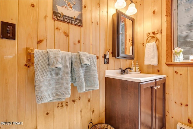91 Bruin Rd, Lake Ariel, PA 18436 - bathroom featuring a baseboard heating unit, vanity, and wooden walls