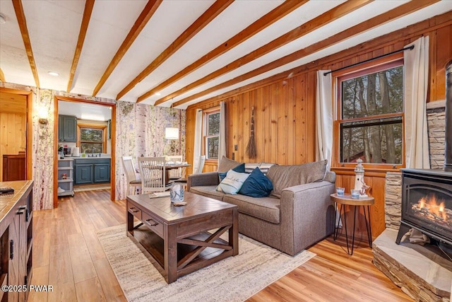 91 Bruin Rd, Lake Ariel, PA 18436 - living area with plenty of natural light, beam ceiling, light wood finished floors, and a wood stove