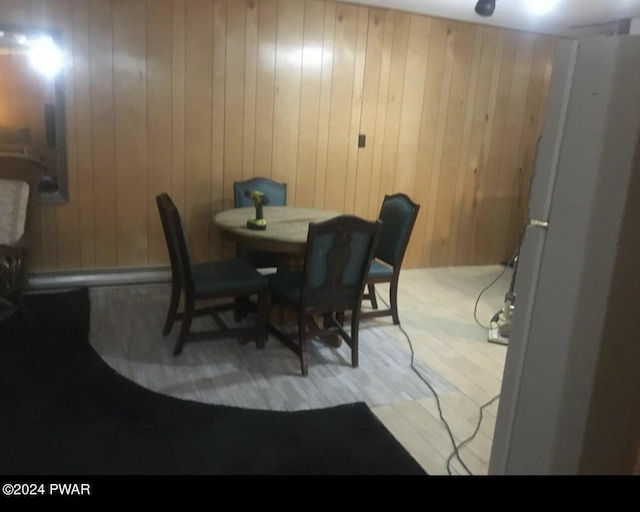 dining space with wooden walls