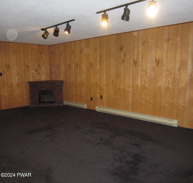 unfurnished living room with baseboard heating, a fireplace, and wooden walls