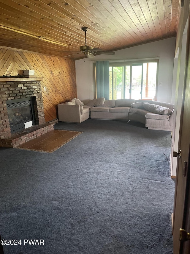 unfurnished living room featuring ceiling fan, wooden ceiling, wooden walls, and a brick fireplace