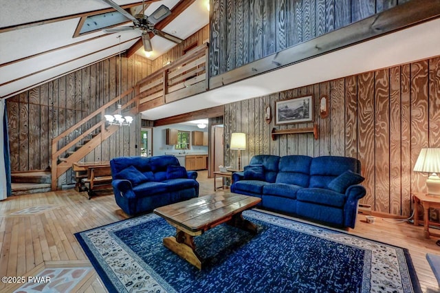 24 Lakewood Dr, Lake Ariel, PA 18436 - living room with wooden walls, hardwood / wood-style floors, a towering ceiling, a ceiling fan, and stairs
